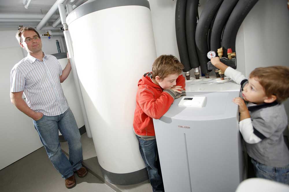 Two kids playing around a water heater