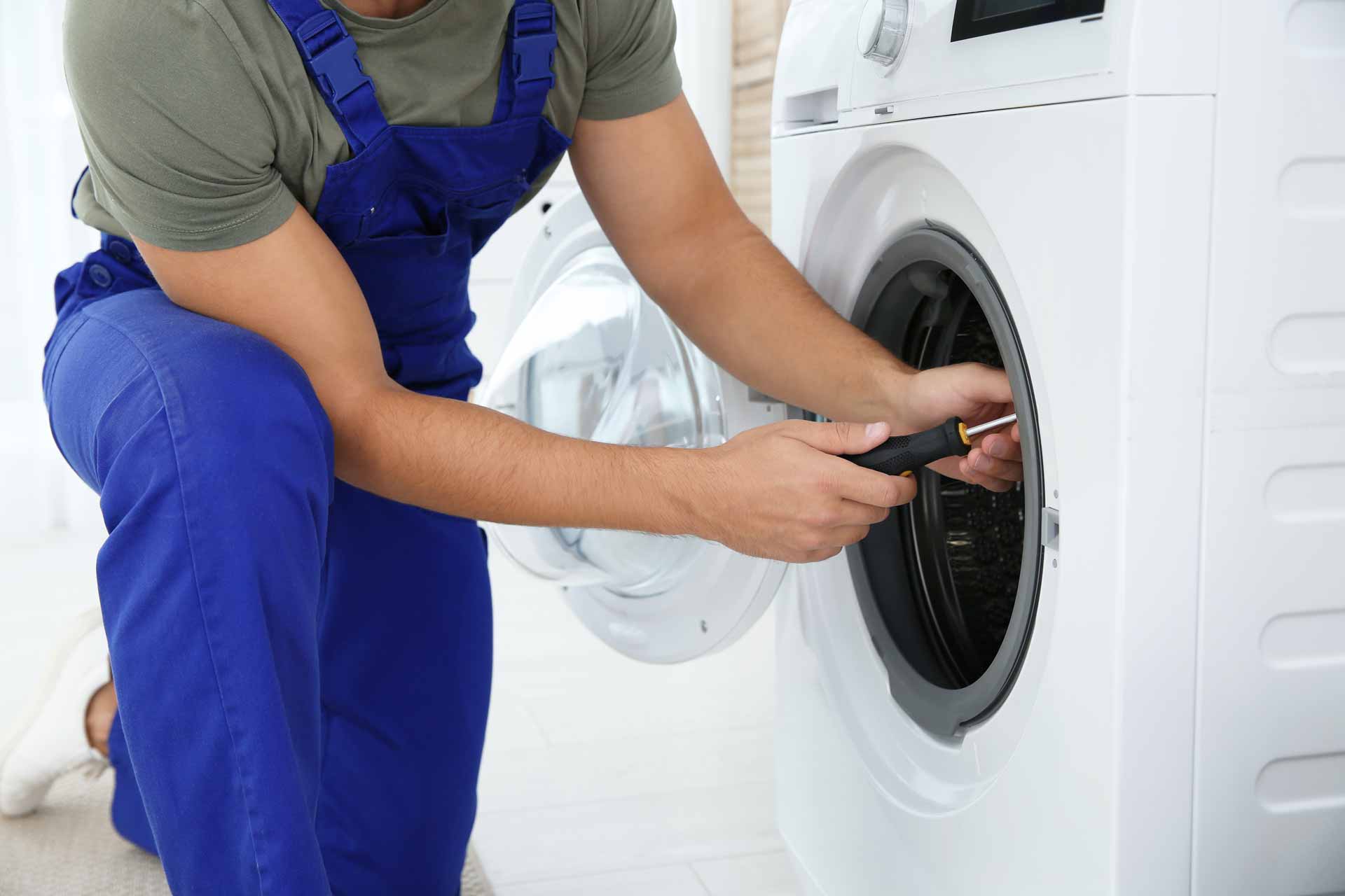 Technician repairing the drum of a washer/dryer